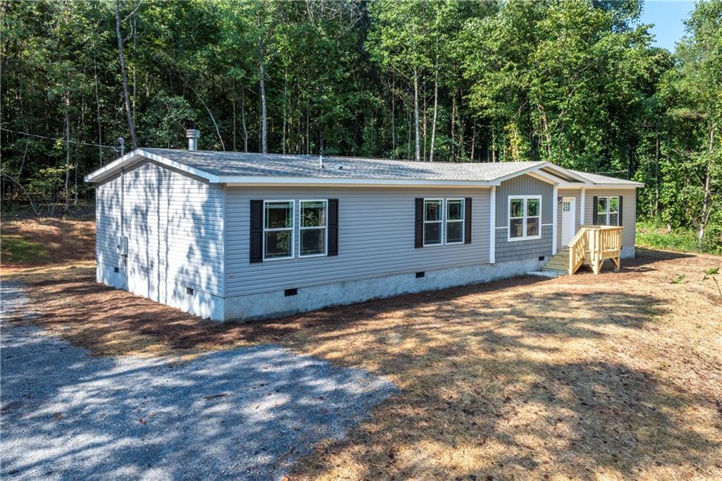 10209 Kelly Bridge Road Dawsonville, GA 30534 - Photo 1 of 31 a view of a house with a yard