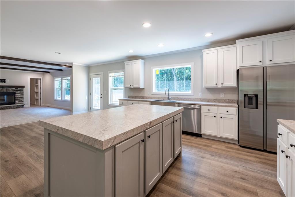 10209 Kelly Bridge Road Dawsonville, GA 30534 - Photo 14 of 31 a kitchen with a center island appliances and cabinets