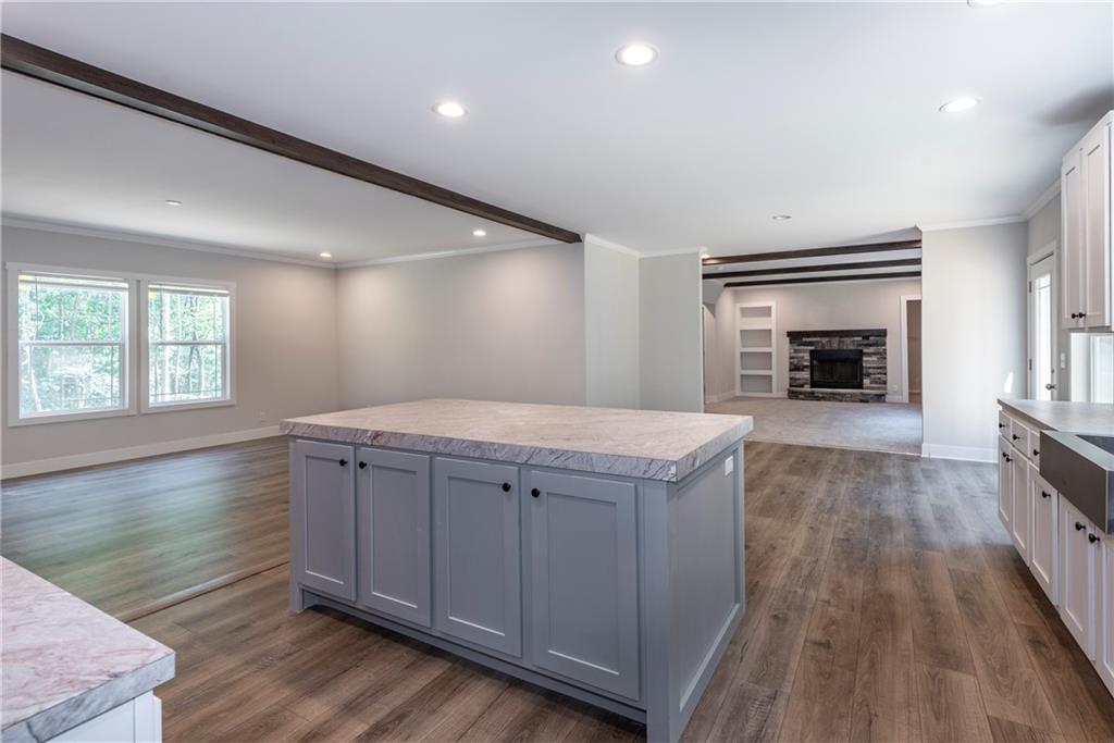 10209 Kelly Bridge Road Dawsonville, GA 30534 - Photo 15 of 31 an empty room with wooden floor fireplace and windows
