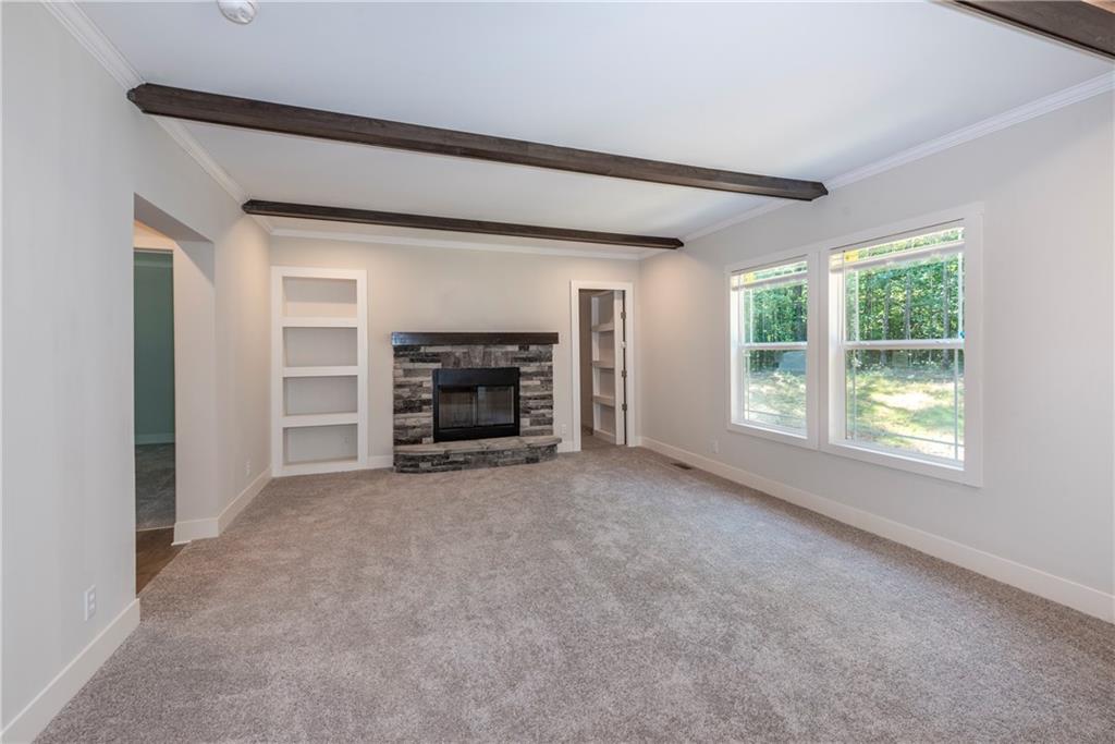 10209 Kelly Bridge Road Dawsonville, GA 30534 - Photo 17 of 31 an empty room with furniture and a fireplace