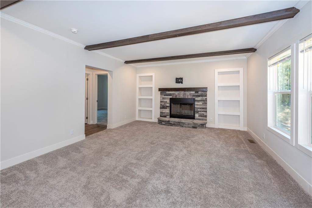10209 Kelly Bridge Road Dawsonville, GA 30534 - Photo 19 of 31 a view of empty room with a fireplace and windows