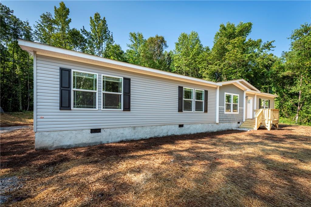 10209 Kelly Bridge Road Dawsonville, GA 30534 - Photo 2 of 31 a view of a house with a yard
