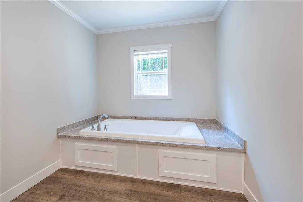 10209 Kelly Bridge Road Dawsonville, GA 30534 - Photo 25 of 31 a bathroom with a sink and vanity