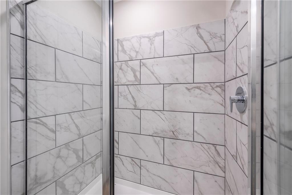 10209 Kelly Bridge Road Dawsonville, GA 30534 - Photo 27 of 31 a bathroom with a close view of a glass door shower