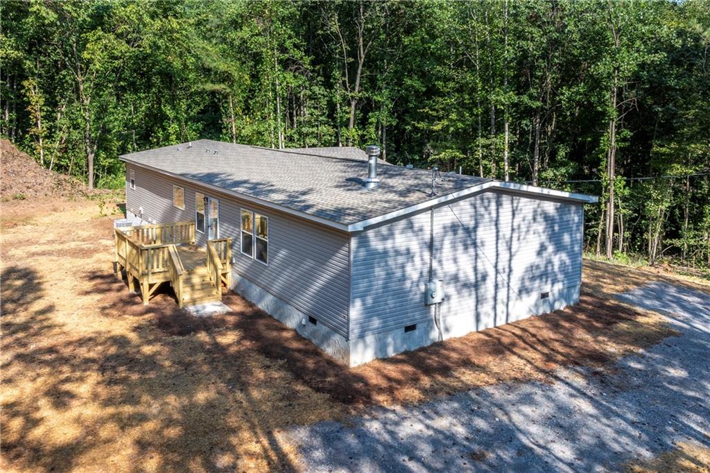 10209 Kelly Bridge Road Dawsonville, GA 30534 - Photo 3 of 31 a view of a roof deck with wooden fence and a big yard