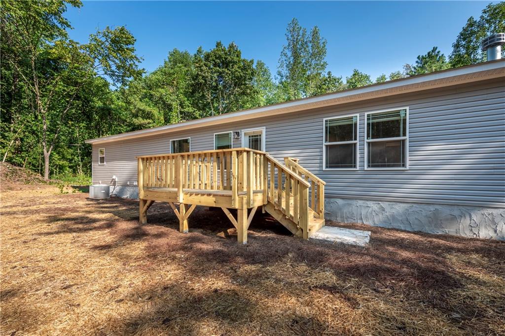 10209 Kelly Bridge Road Dawsonville, GA 30534 - Photo 4 of 31 a view of a house with backyard and patio