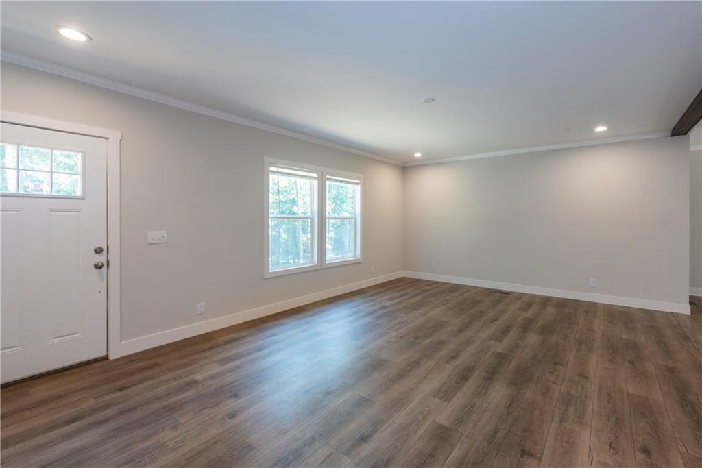 10209 Kelly Bridge Road Dawsonville, GA 30534 - Photo 8 of 31 an empty room with wooden floor and windows