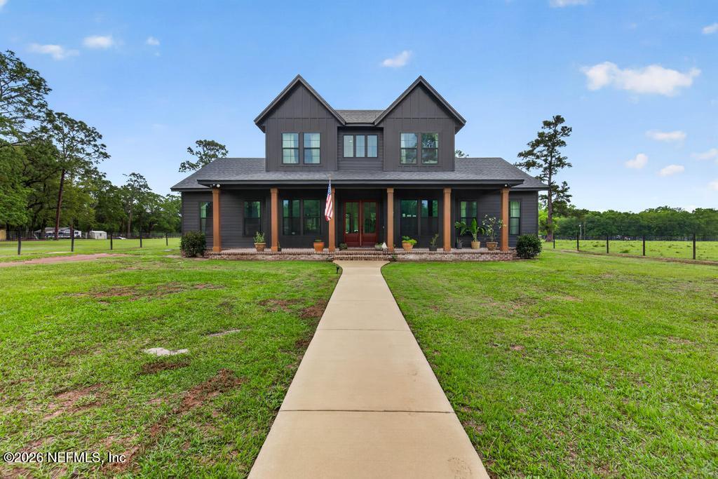 2955 Carroll Corner Road Hilliard, FL 32046 - Photo 3 of 106 a front view of a house with a yard