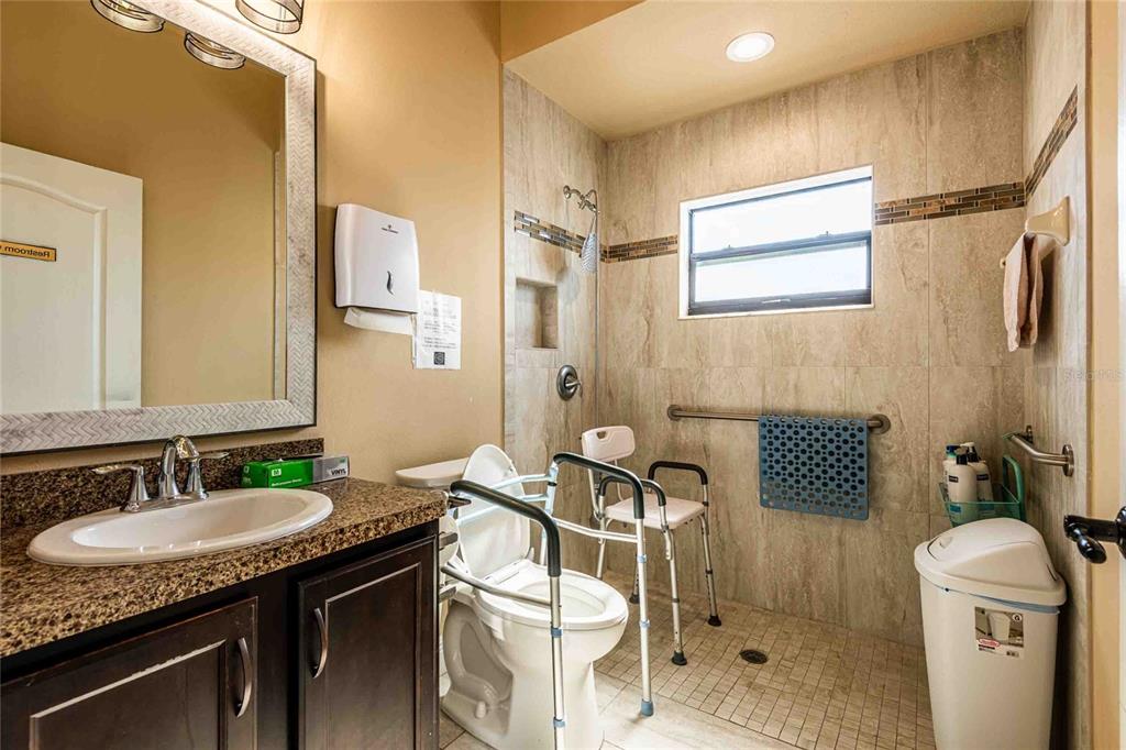 Undisclosed Address Spring Hill, FL 34608 - Photo 18 of 39 a bathroom with a sink a toilet a mirror and shower