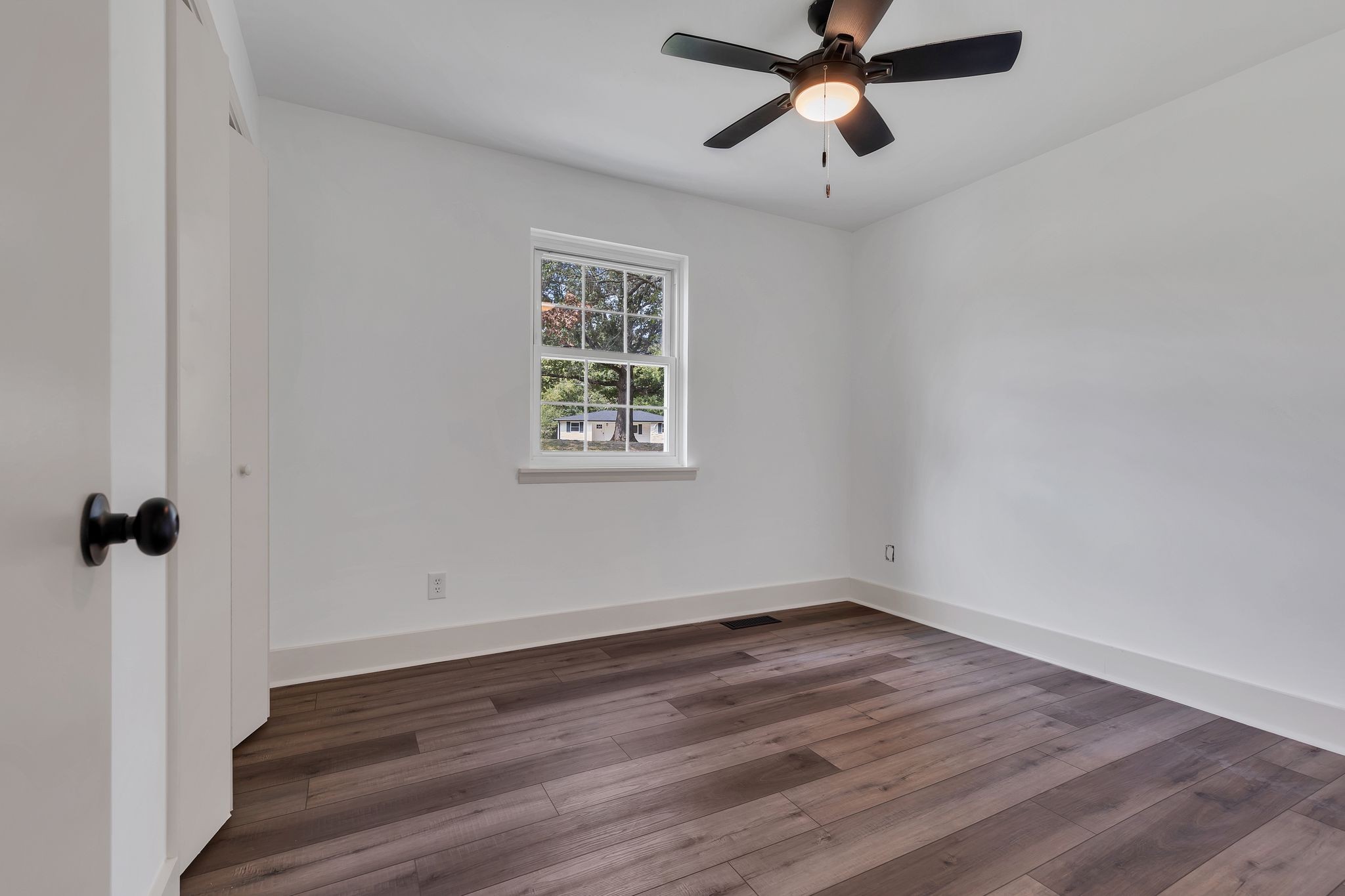 1450 Southside Road Southside, TN 37171 - Photo 22 of 41 a view of a room with wooden floor ceiling fan and window