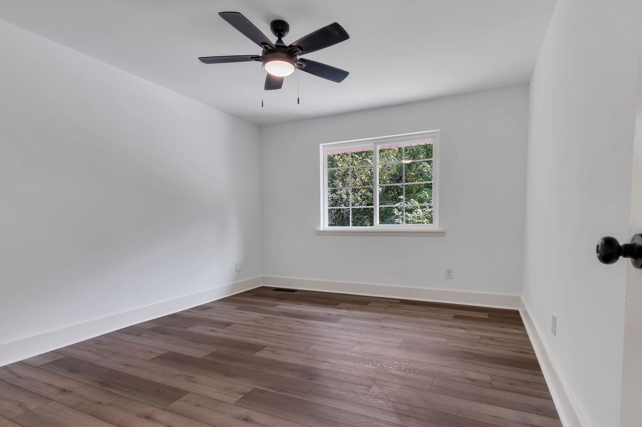 1450 Southside Road Southside, TN 37171 - Photo 24 of 41 an empty room with wooden floor and windows