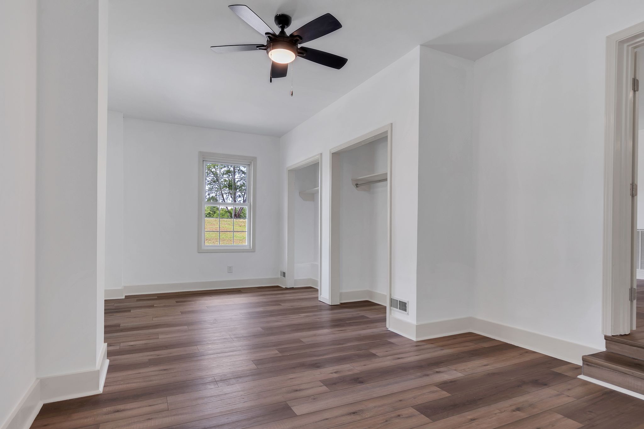 1450 Southside Road Southside, TN 37171 - Photo 10 of 41 an empty room with wooden floor fan and windows