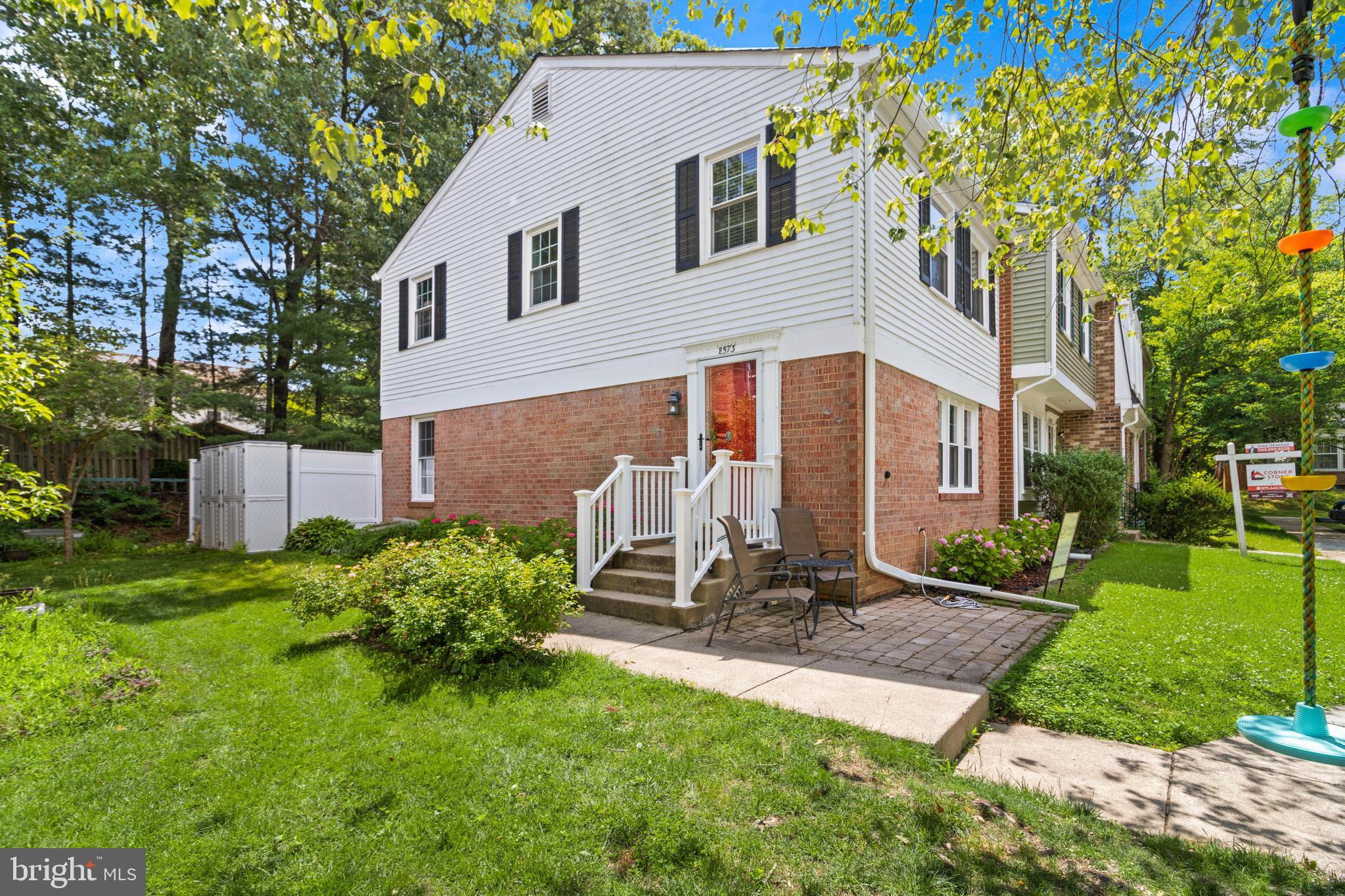 8573 Tyrolean Way Springfield, VA 22153 - Photo 25 of 32 a view of a white house with a yard and plants
