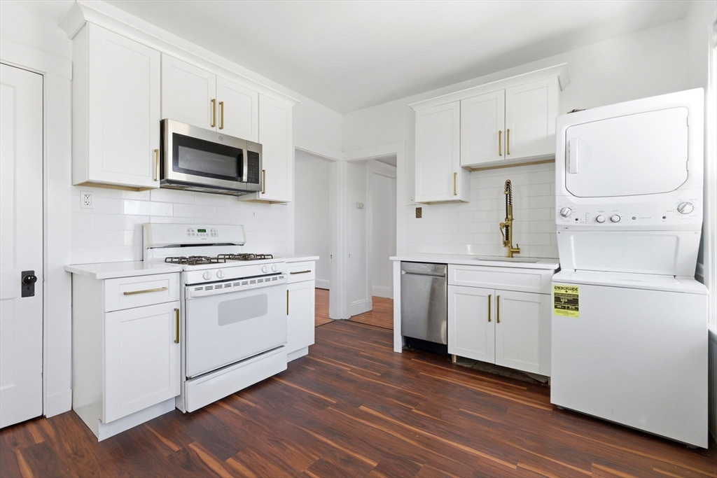 9 Sumner Square Boston, MA 02125 - Photo 2 of 10 a kitchen with white cabinets stainless steel appliances and sink