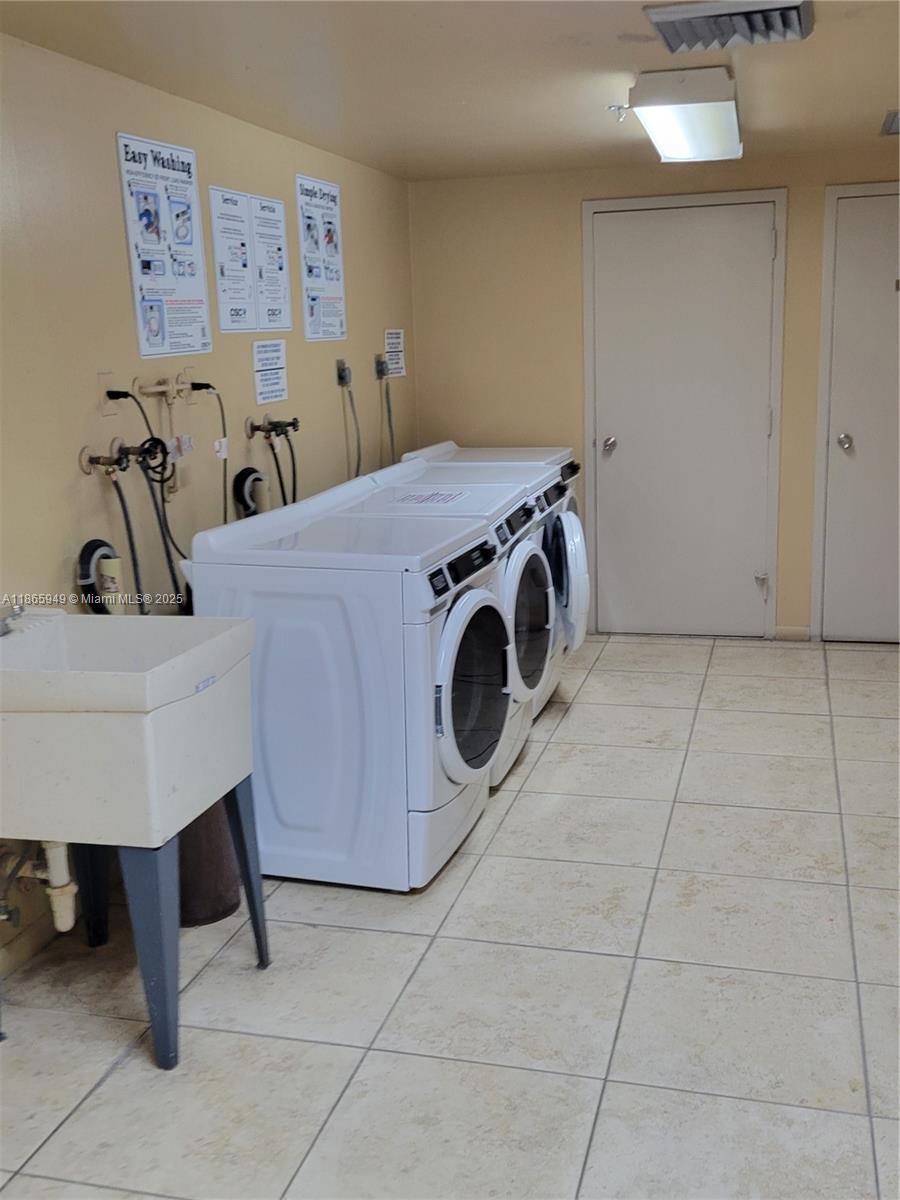 919 Hillcrest Drive, Unit 306 Hollywood, FL 33021 - Photo 27 of 30 a utility room with dryer and washer