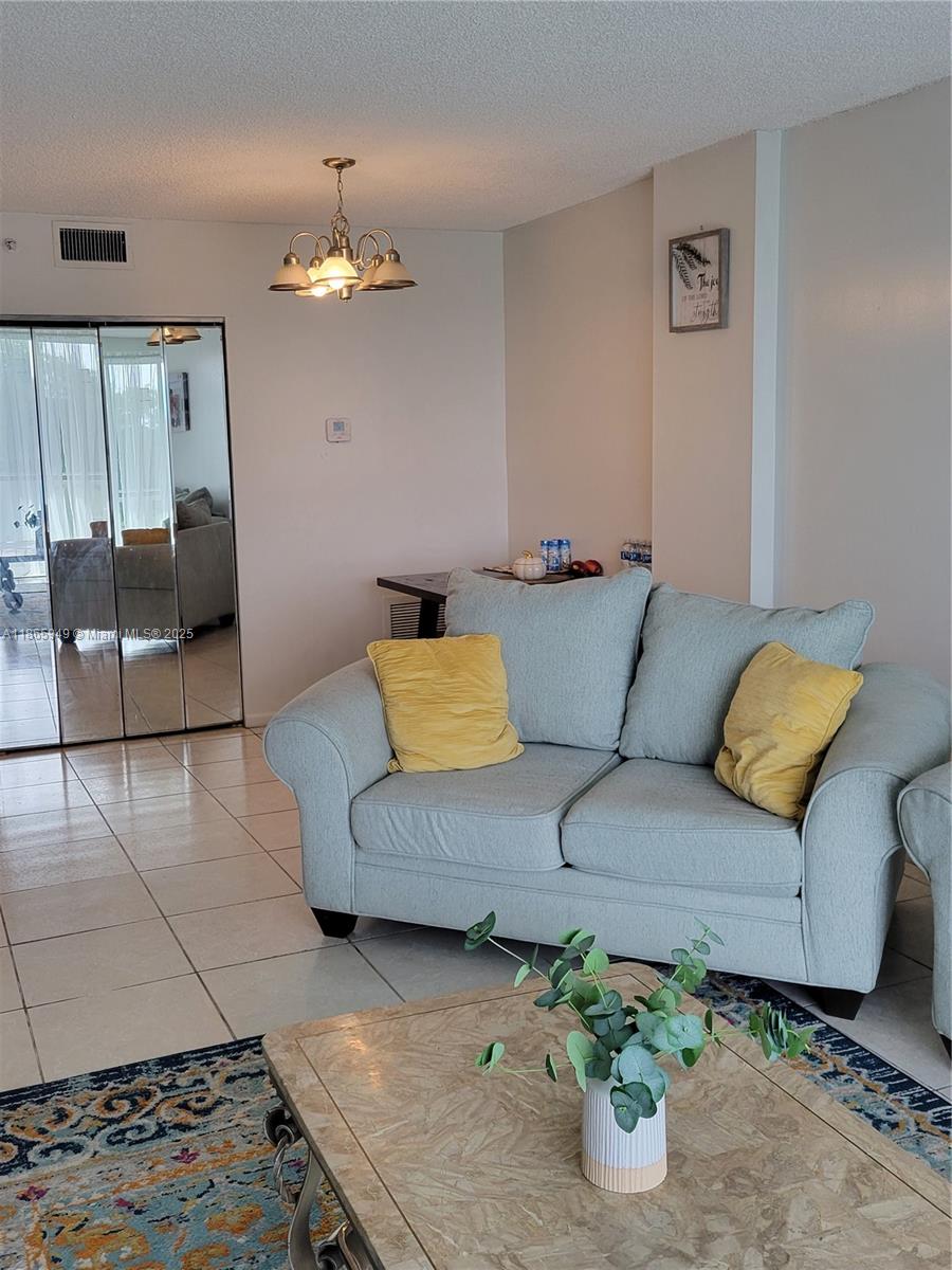 919 Hillcrest Drive, Unit 306 Hollywood, FL 33021 - Photo 5 of 30 a living room with furniture and a chandelier