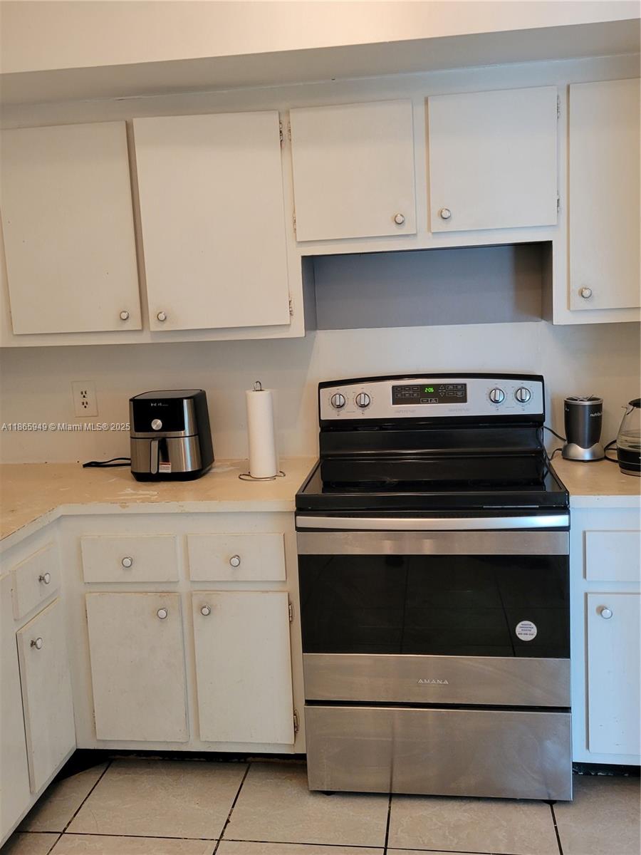 919 Hillcrest Drive, Unit 306 Hollywood, FL 33021 - Photo 8 of 30 a kitchen with white cabinets and appliances