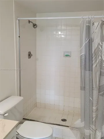 a bathroom with a shower and toilet