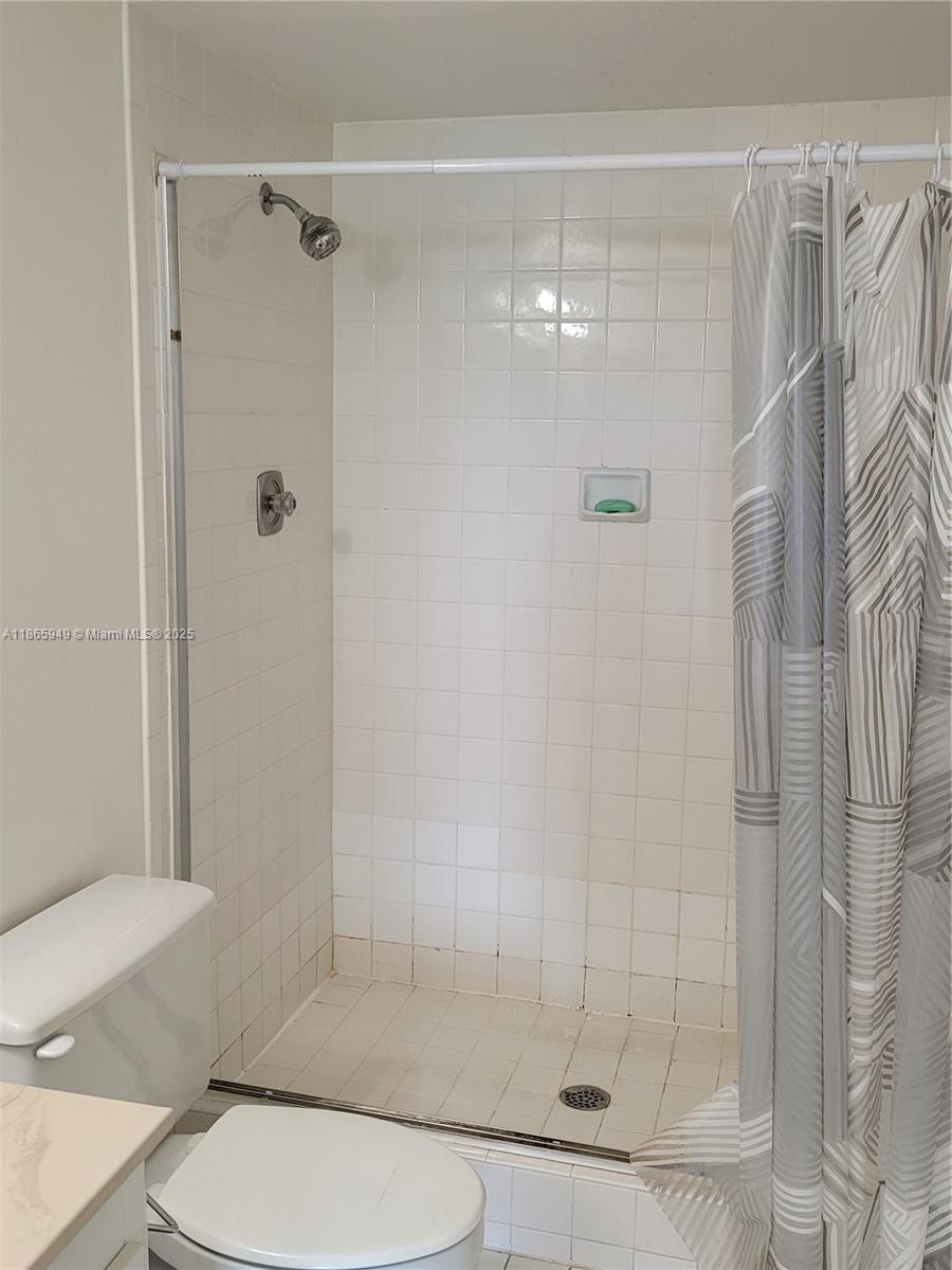 919 Hillcrest Drive, Unit 306 Hollywood, FL 33021 - Photo 10 of 30 a bathroom with a shower and toilet