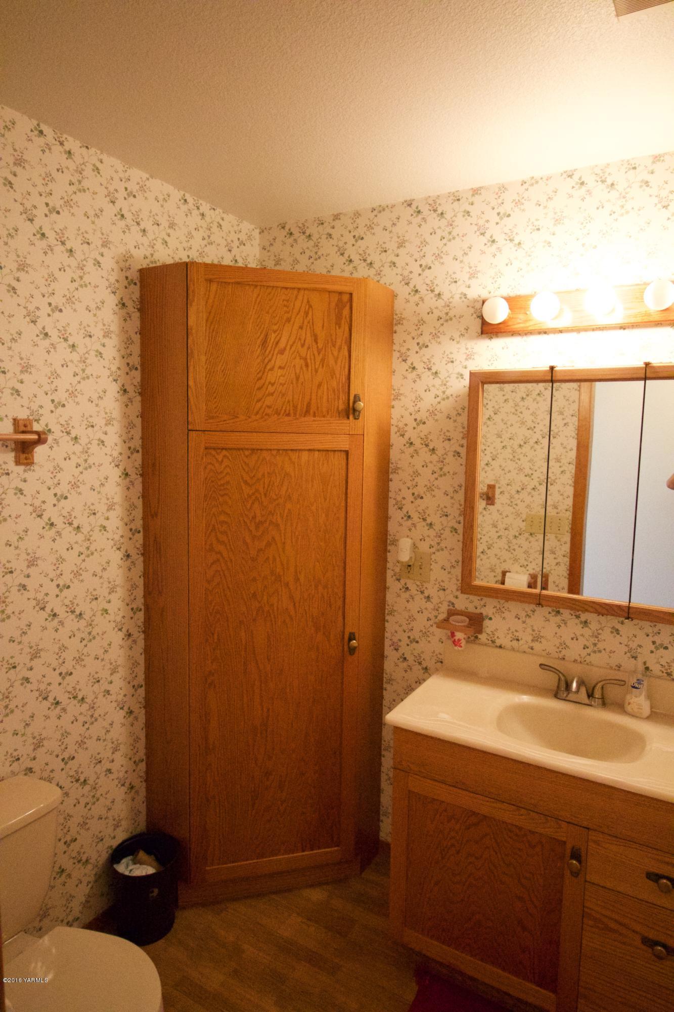 12831 Nelson Road Yakima, WA 98903 - Photo 11 of 24 a bathroom with a granite countertop sink and a mirror