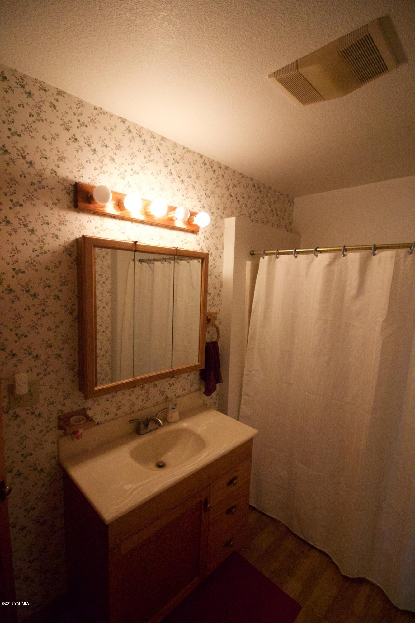 12831 Nelson Road Yakima, WA 98903 - Photo 12 of 24 a bathroom with a sink and a mirror