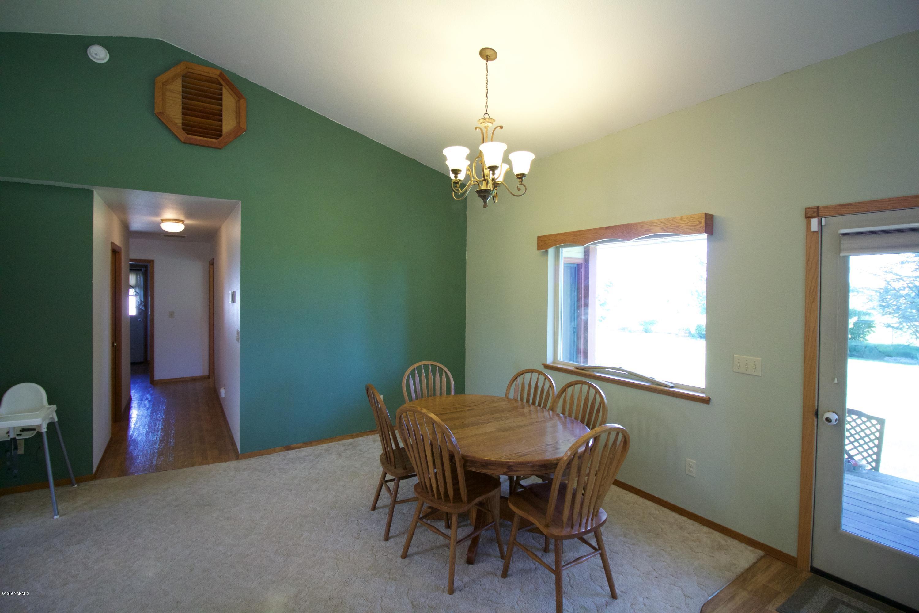 12831 Nelson Road Yakima, WA 98903 - Photo 8 of 24 a view of a dining room with furniture and a chandelier