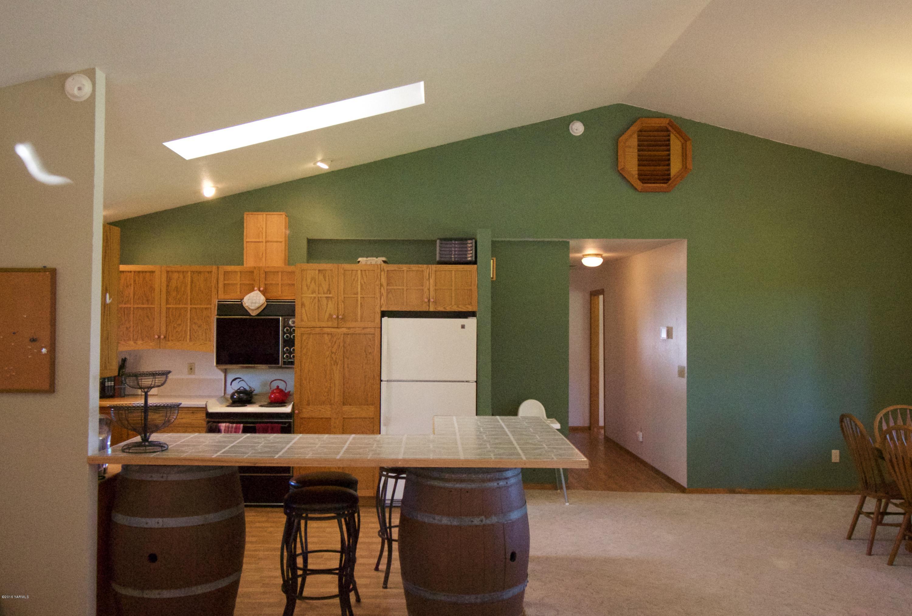 12831 Nelson Road Yakima, WA 98903 - Photo 9 of 24 a view of a kitchen with a table and chairs