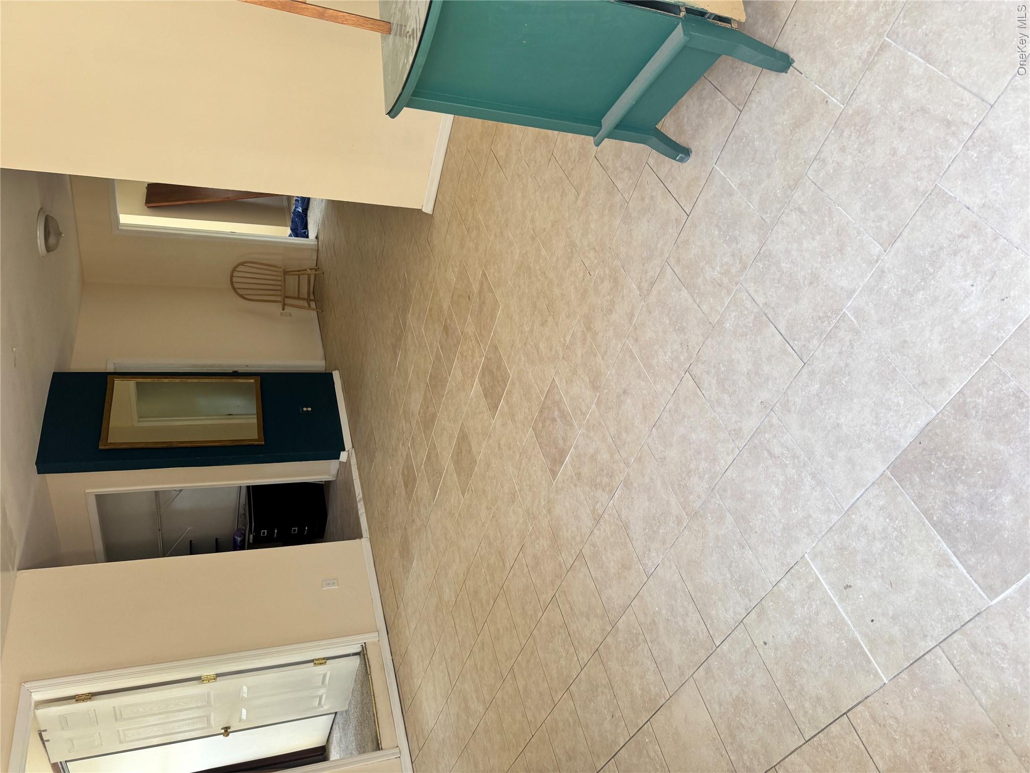 33 Hawthorne Road Rocky Point, NY 11778 - Photo 2 of 5 Light-toned tile flooring throughout an open concept area