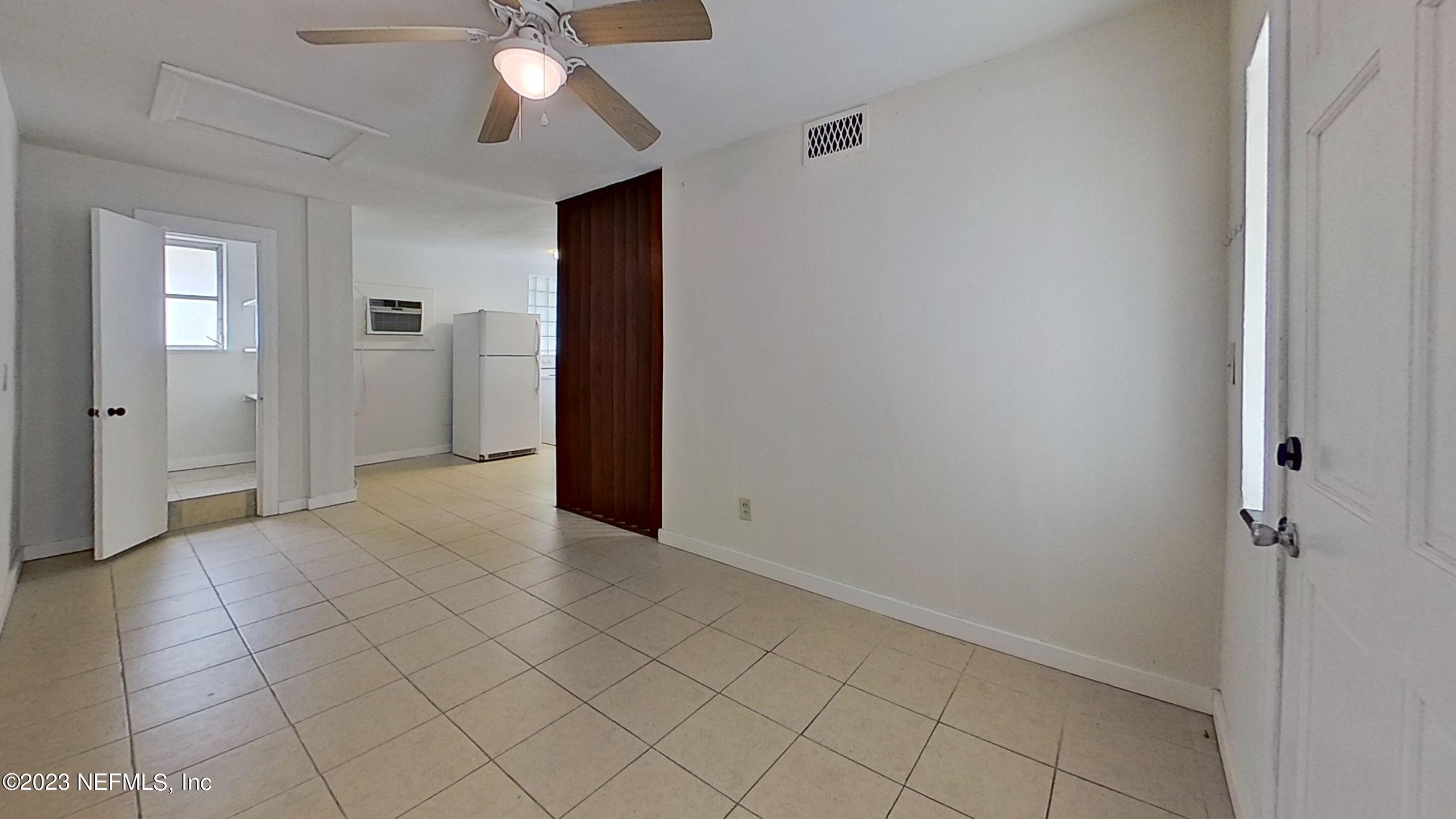 1824 Hendricks Avenue, Unit 1 Jacksonville, FL 32207 - Photo 3 of 11 an empty room with closet and a chandelier fan