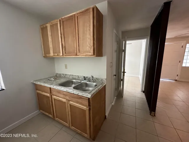 a kitchen with a stove top oven and cabinets
