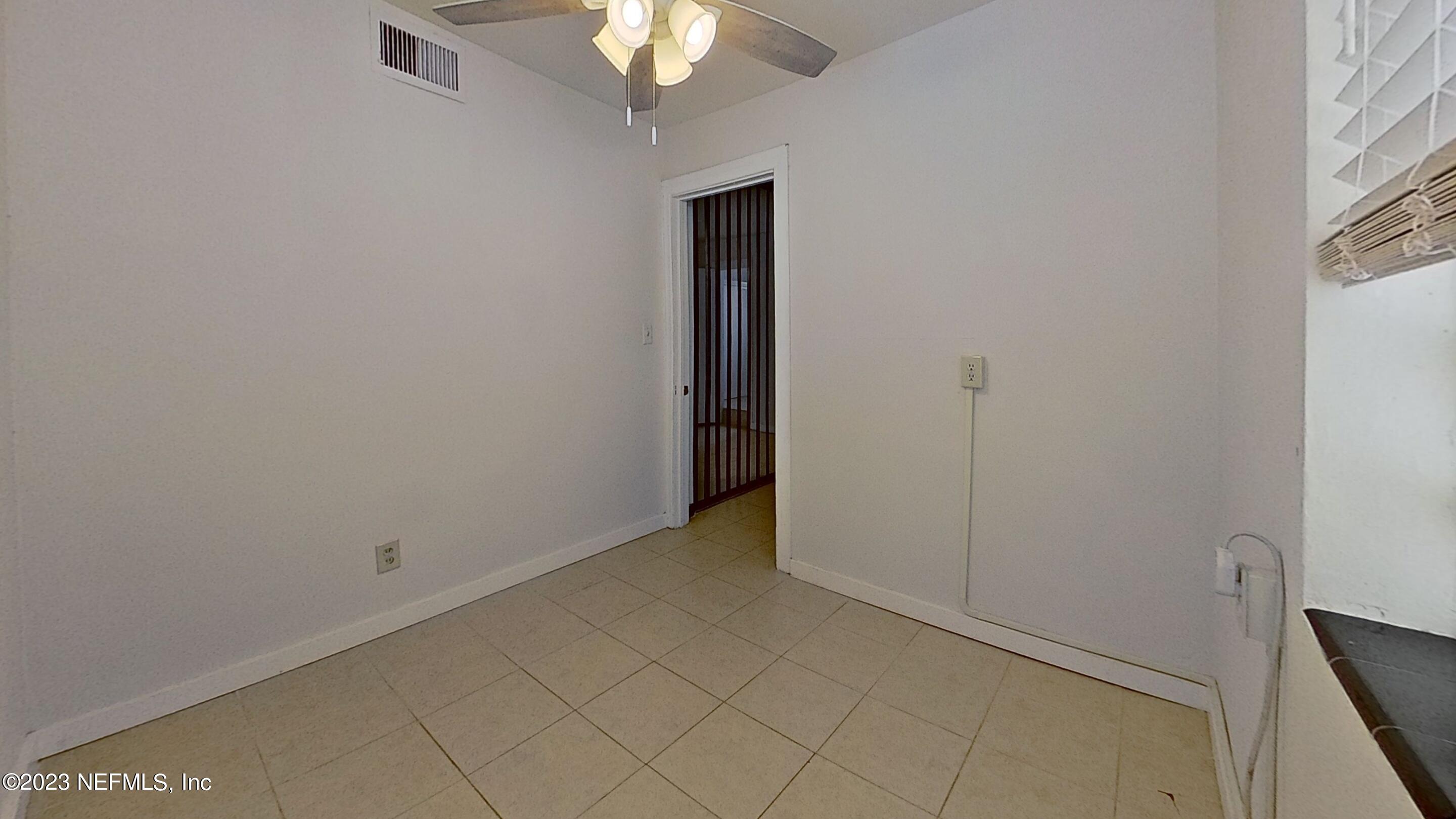 1824 Hendricks Avenue, Unit 1 Jacksonville, FL 32207 - Photo 8 of 11 an empty room with chandelier fan