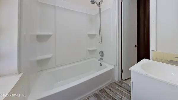 a bathroom with a bathtub and a toilet