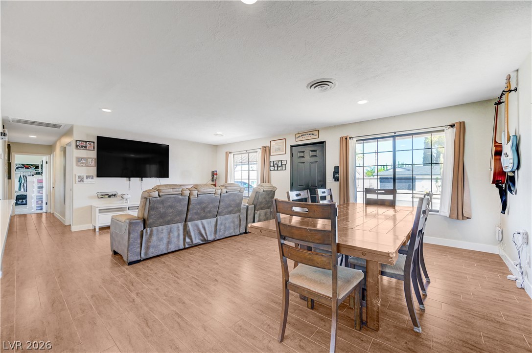 1331 Pinto Road Boulder City, NV 89005 - Photo 17 of 46 An inviting open-concept living and dining area features rich wood flooring, perfect for entertaining.
