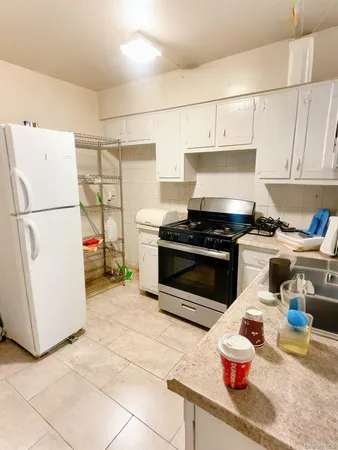 a kitchen with stainless steel appliances a stove a refrigerator and a cabinets