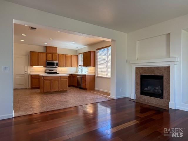 1545 Jainine Street Santa Rosa, CA 95403 - Photo 15 of 19 a living room with stainless steel appliances furniture a fireplace a flat screen tv and a window