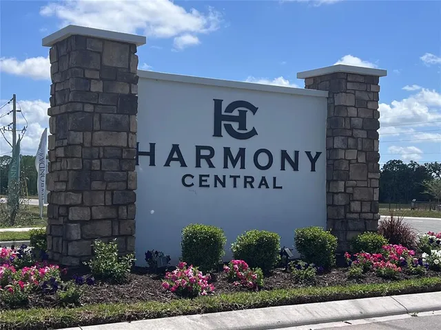 a sign that is in front of flowers