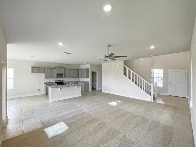 a view of kitchen with cabinets and microwave