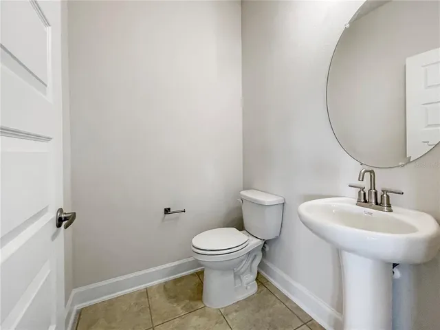 a bathroom with a sink toilet and a mirror