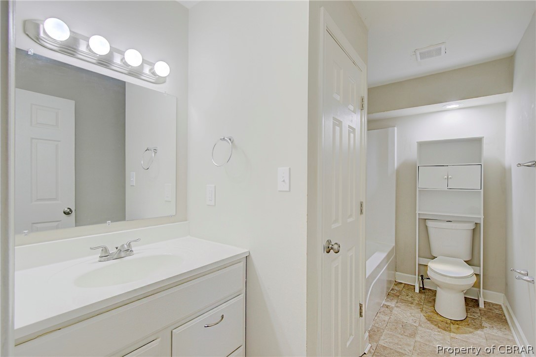 5347 Ware Neck Road Gloucester, VA 23061 - Photo 18 of 36 Full bathroom with tile floors, washtub / shower combination, toilet, and vanity with extensive cabinet space