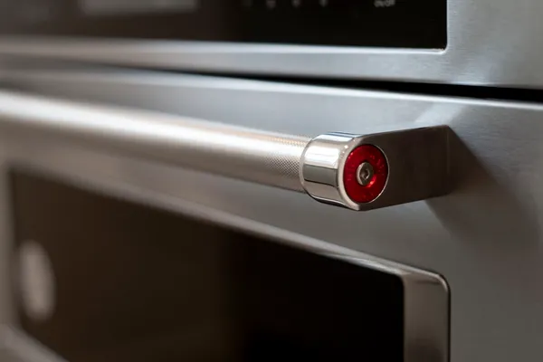 a kitchen with a stove and a granite counter top
