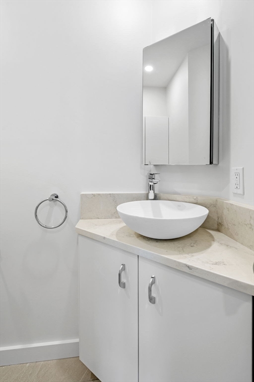 34 Constitution Way, Unit D Marblehead, MA 01945 - Photo 16 of 33 a bathroom with a sink and a mirror