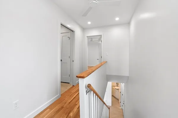 an empty room with wooden floor and a window
