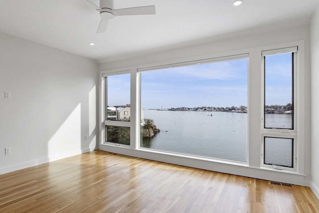 34 Constitution Way, Unit D Marblehead, MA 01945 - Photo 20 of 33 an empty room with wooden floor and a window