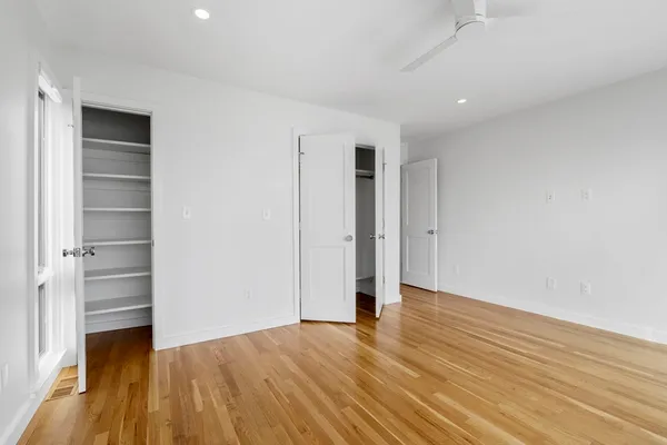a view of an empty room with wooden floor