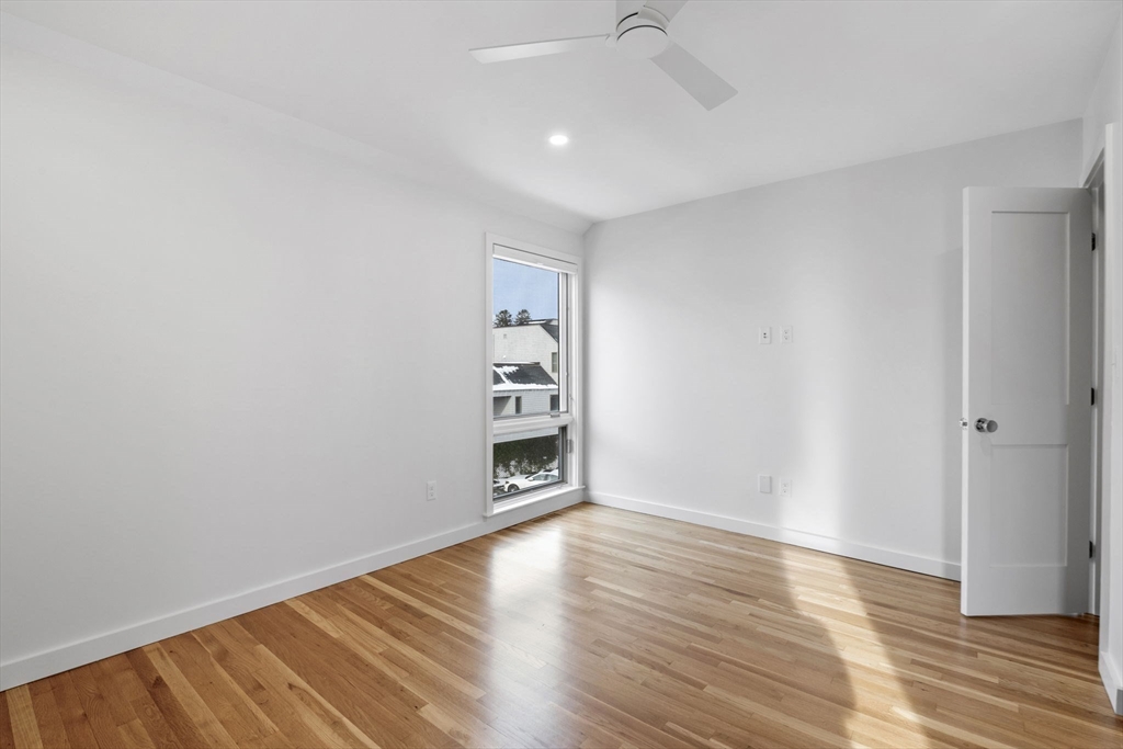 34 Constitution Way, Unit D Marblehead, MA 01945 - Photo 25 of 33 an empty room with wooden floor closet and windows