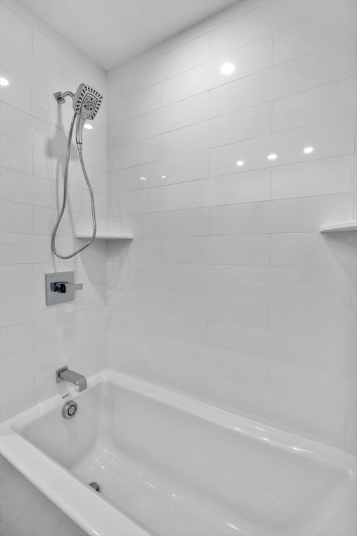 34 Constitution Way, Unit D Marblehead, MA 01945 - Photo 30 of 33 a bathroom with a bath tub with a shower