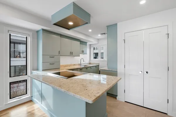 a kitchen with stainless steel appliances granite countertop a sink and a refrigerator