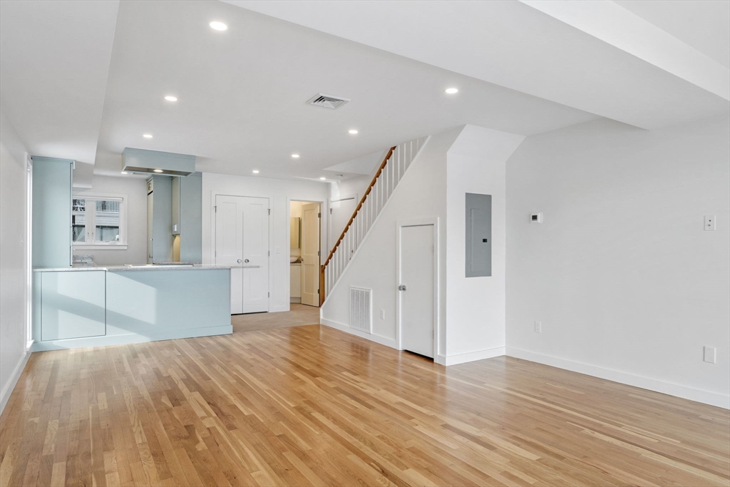 34 Constitution Way, Unit D Marblehead, MA 01945 - Photo 5 of 33 a view of a hallway with wooden floor and staircase