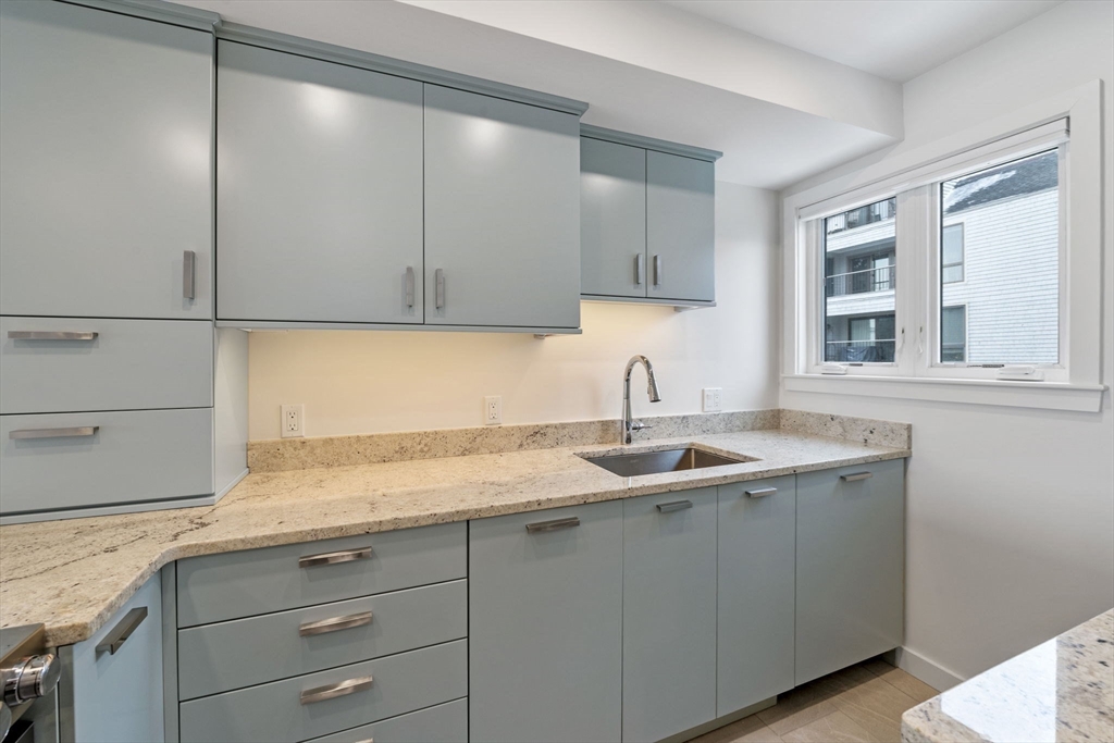 34 Constitution Way, Unit D Marblehead, MA 01945 - Photo 8 of 33 a kitchen with a sink and cabinets