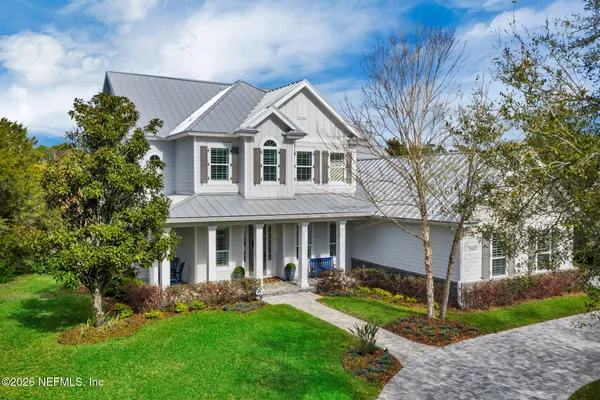 a front view of a house with a yard and porch